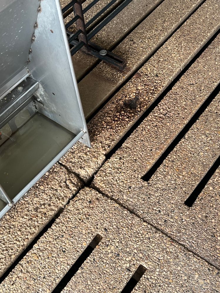 A close up of a wooden floor with a hole in it.