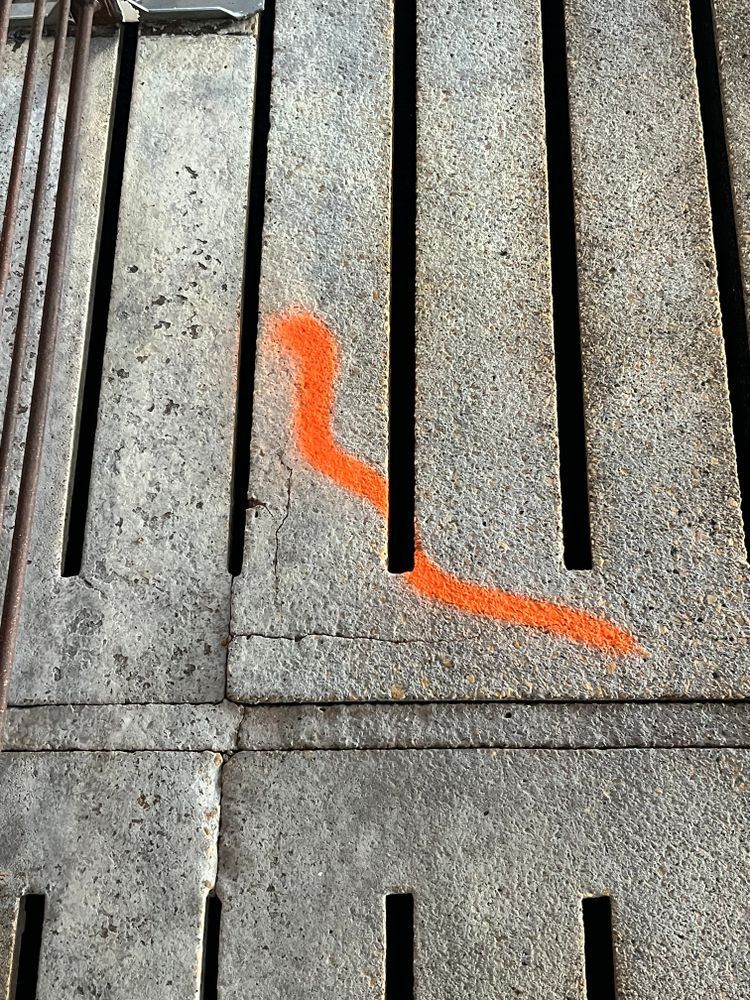 A red line is painted on a concrete surface.