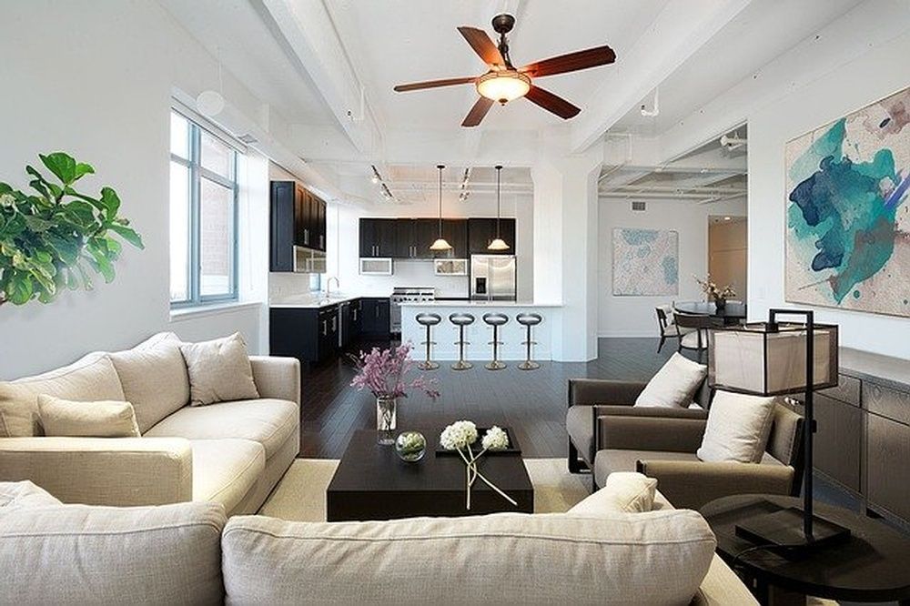 A living room with a ceiling fan and a couch