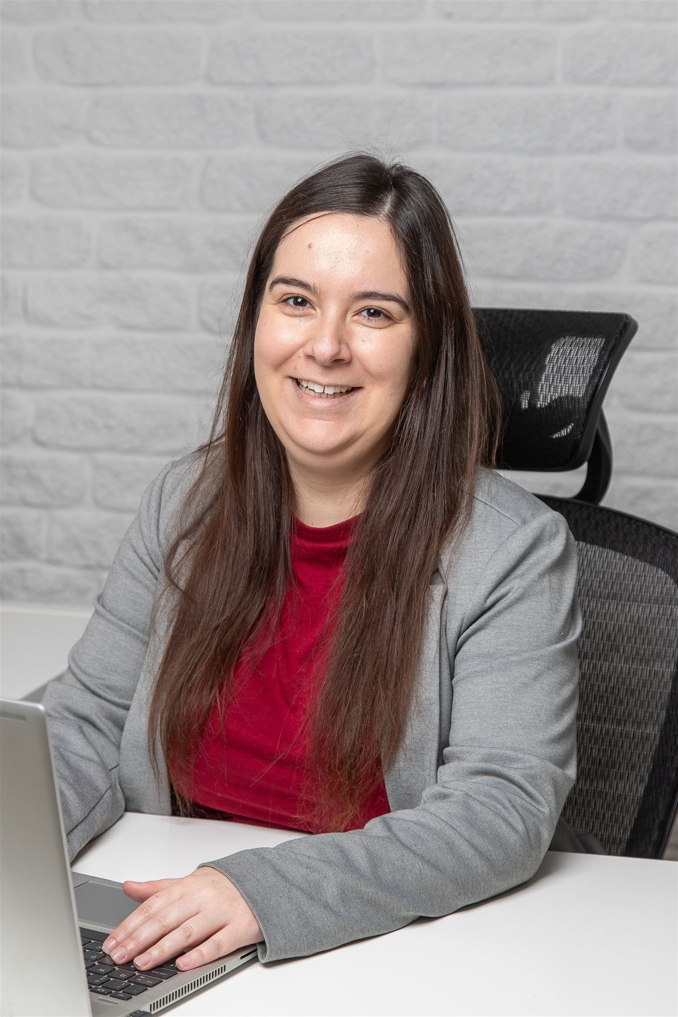 A close up of a woman 's face with a dark background.