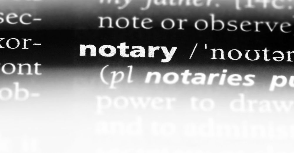 A black and white photo of the word notary