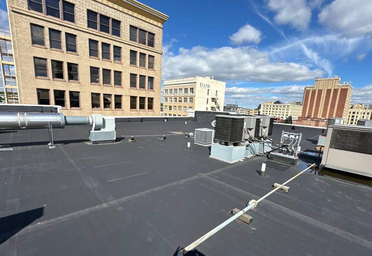 The roof of a building with a black roof and a lot of windows.