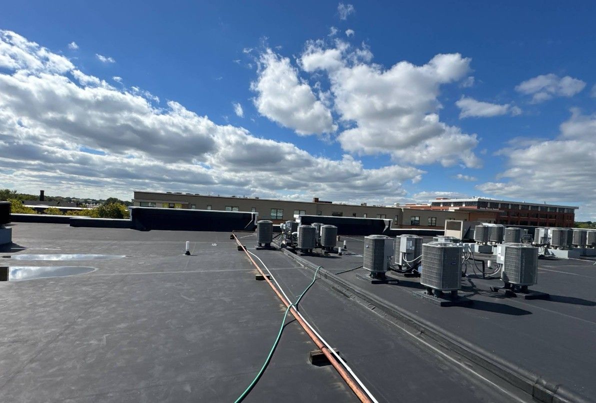 The roof of a building with a lot of air conditioners on it