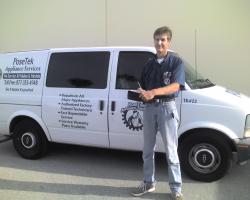 Man standing in front of a white van, with PoseTek Appliance Services logo, holding a clipboard.