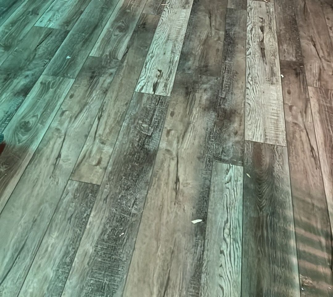 A close up of a wooden floor in a room.