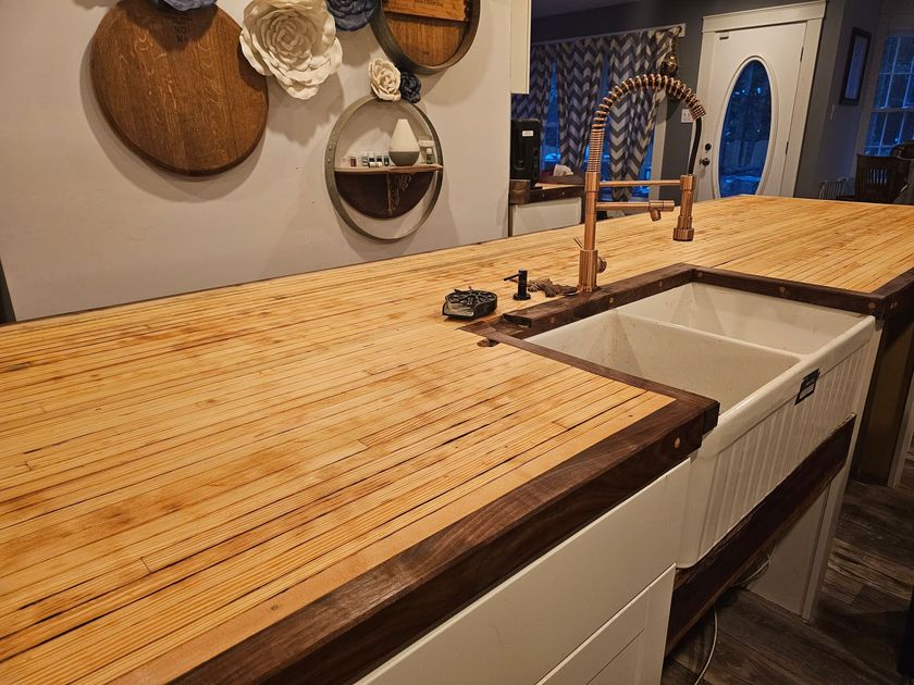 A kitchen with two sinks and a wooden counter top.