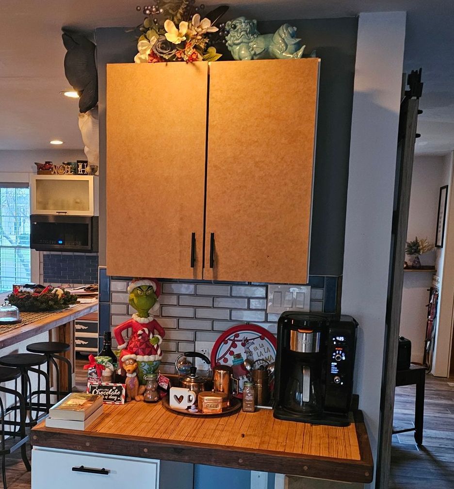 A kitchen with wooden cabinets and a coffee maker