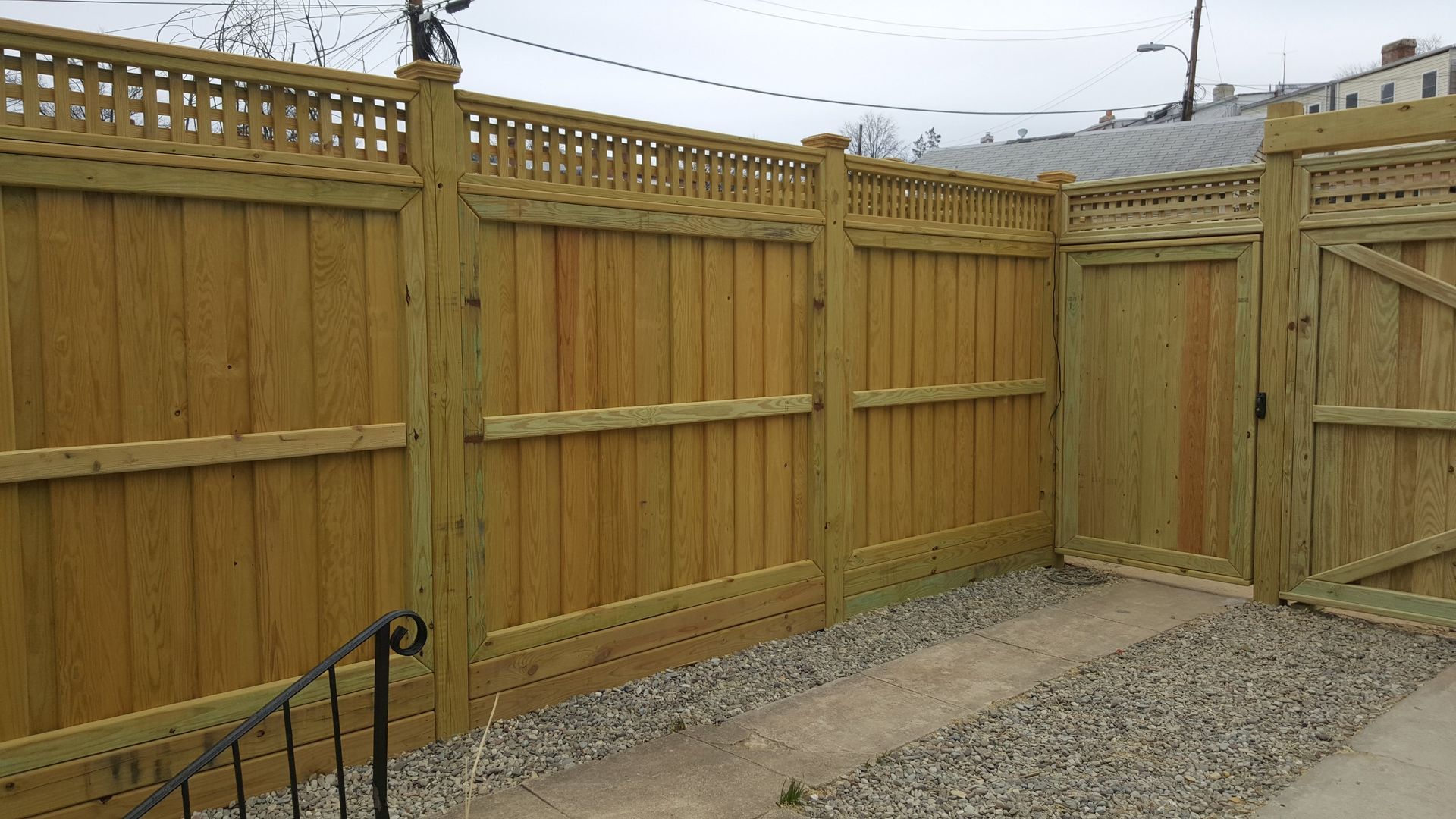 A wooden fence with a gate in the middle of it.