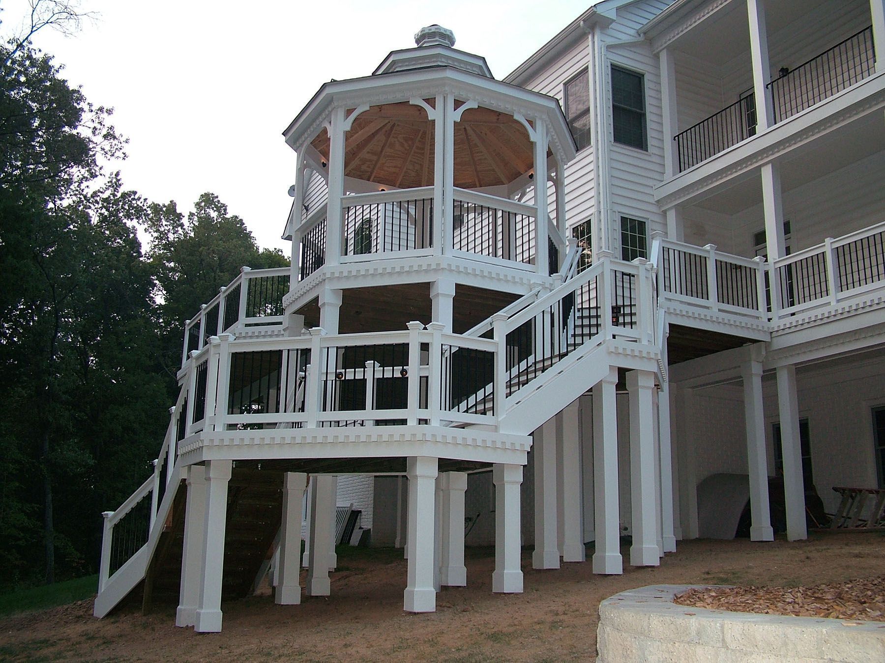 A large white house with a gazebo and stairs