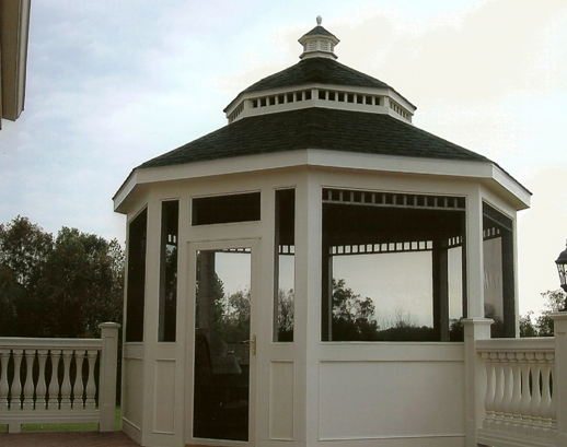 A white gazebo with a black roof and a screen door