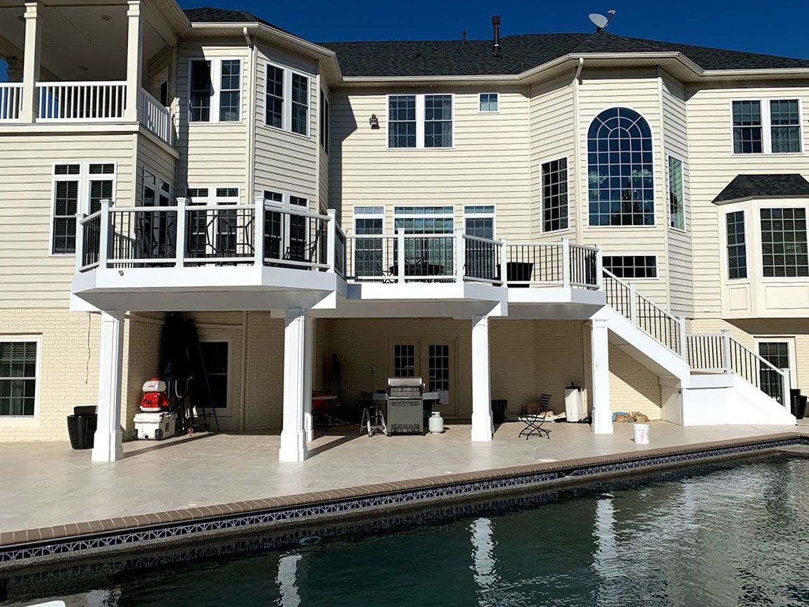 A large house with a swimming pool in front of it.
