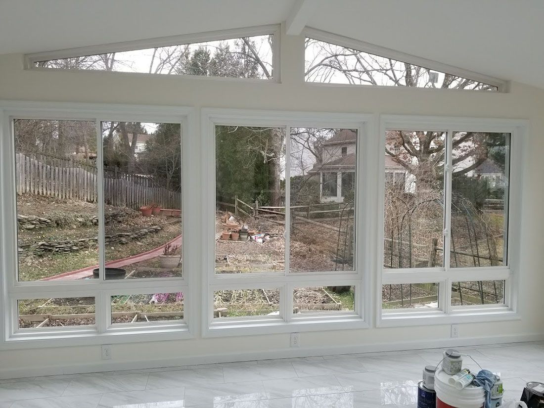 A room with a lot of windows and a vaulted ceiling.