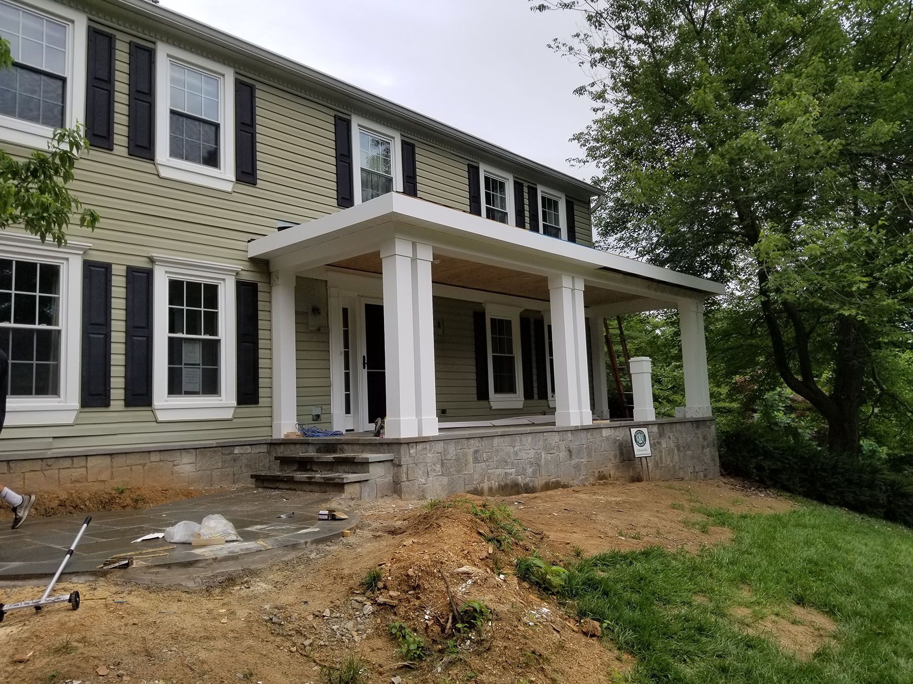 A large house with a porch and a lot of windows.