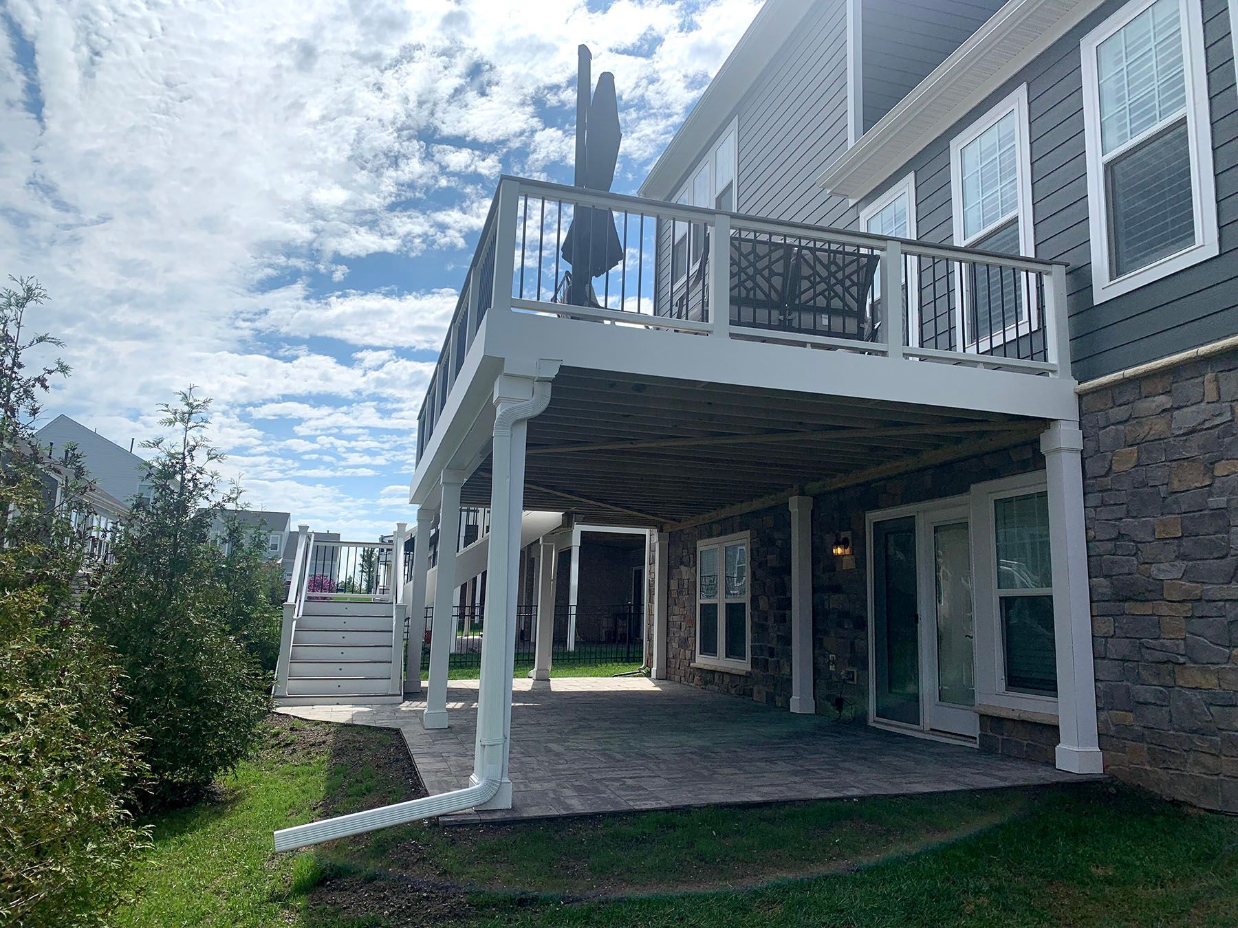 A large house with a large deck and patio.