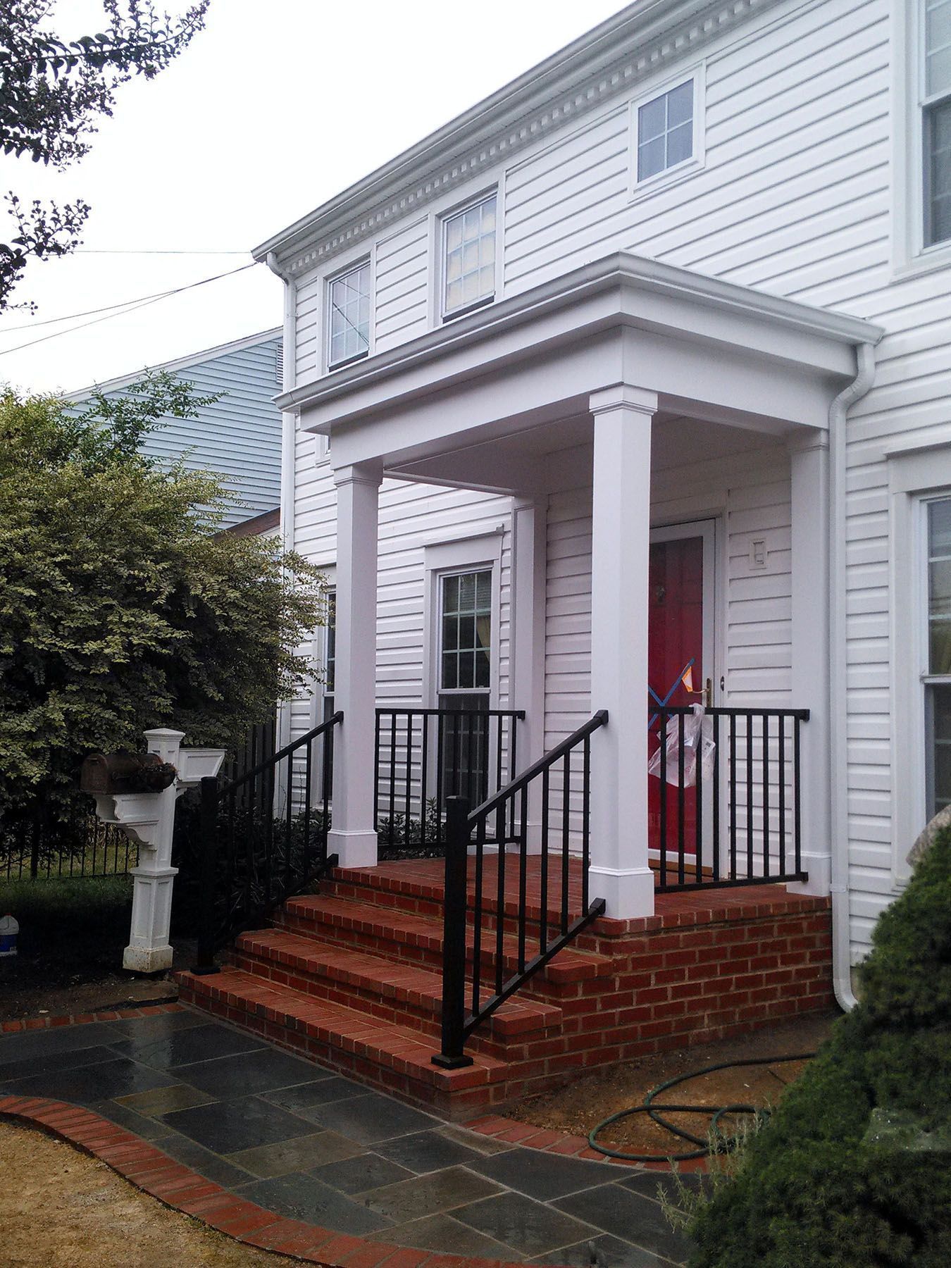 A white house with a porch and stairs