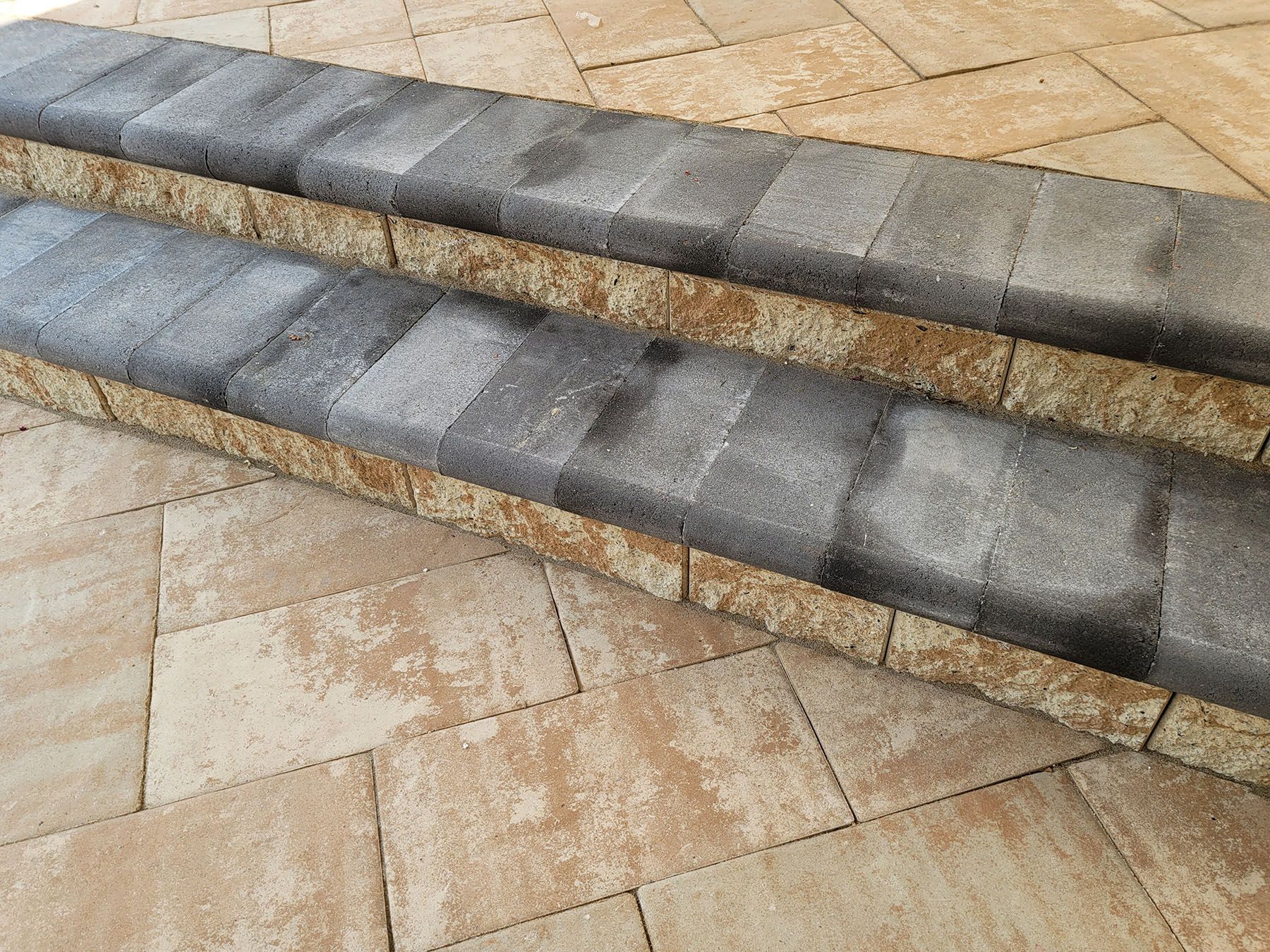 A close up of a set of stairs made of bricks on a patio.