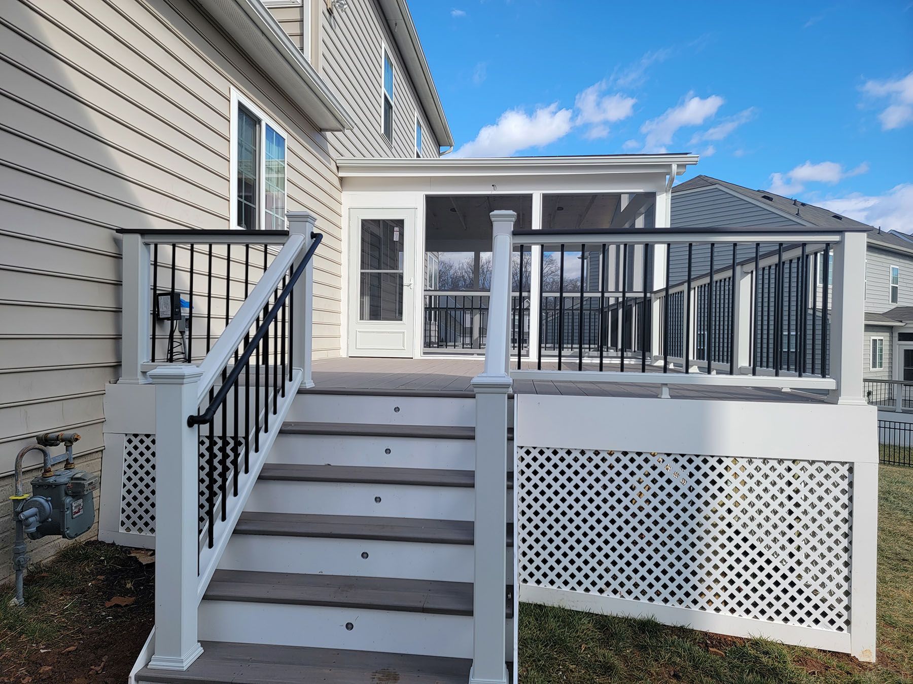 There is a screened in porch with stairs leading up to it.