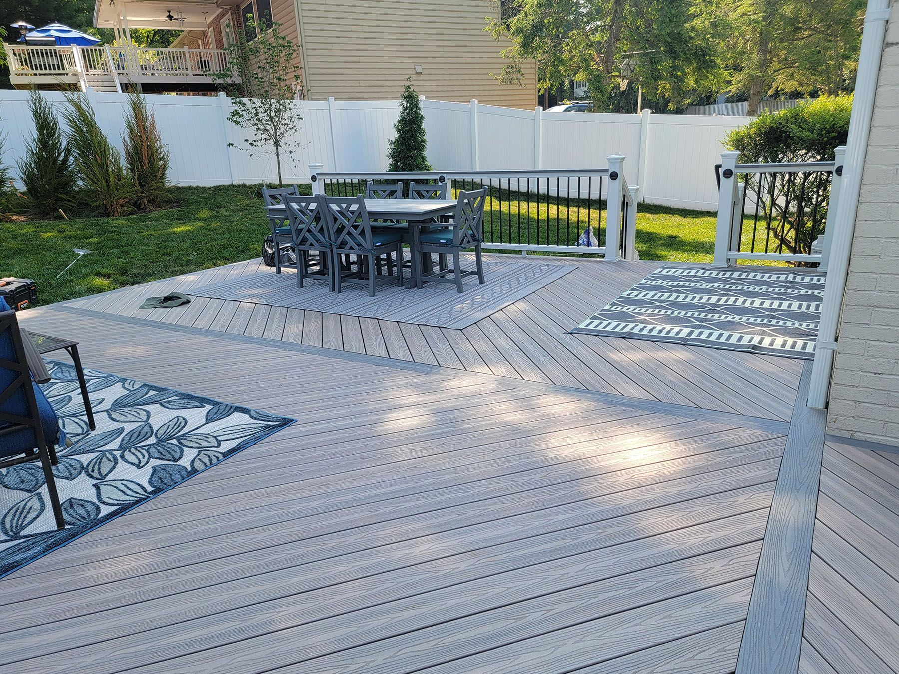 There is a patio with a table and chairs on it.