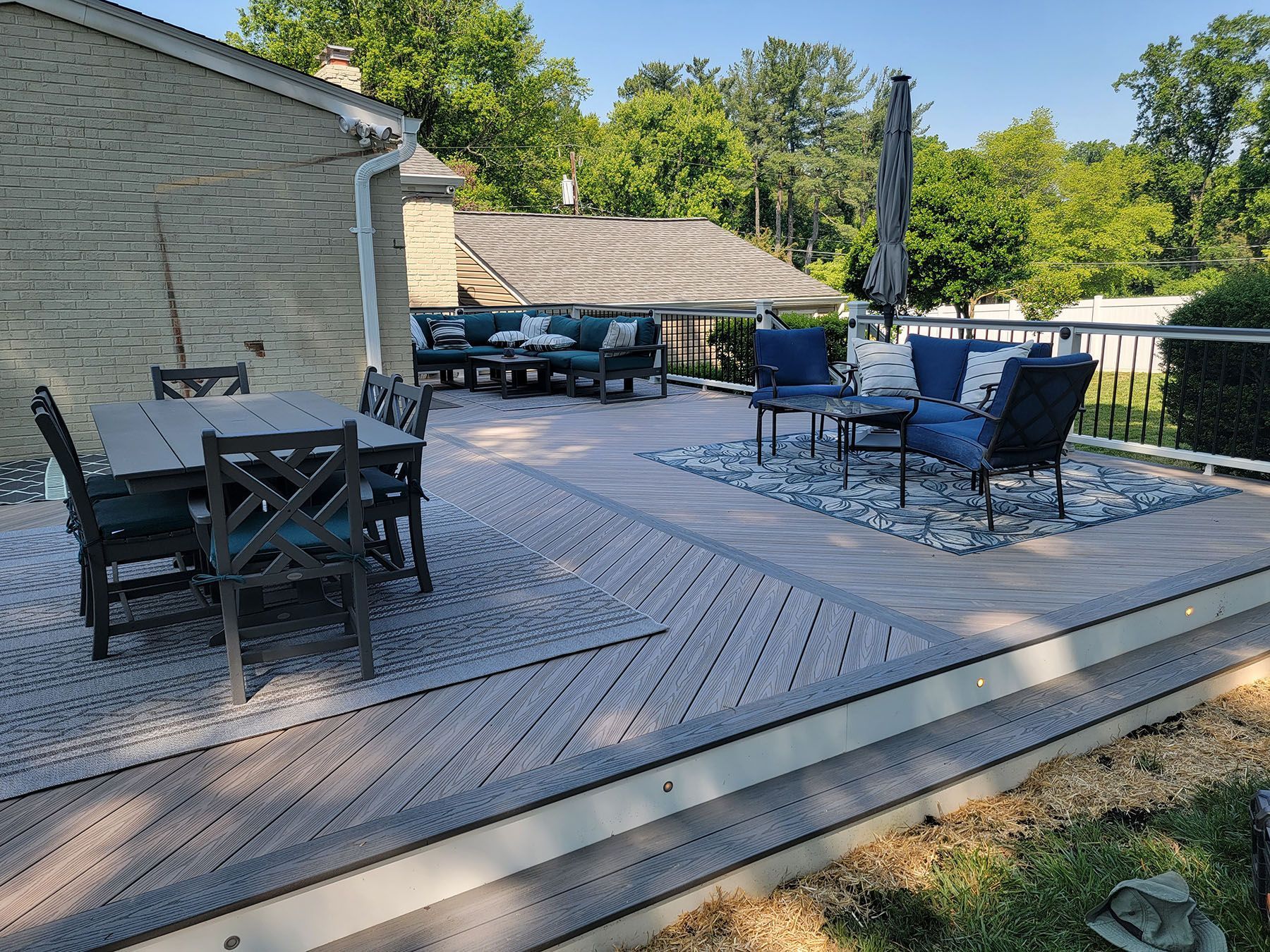 There is a large deck with a table and chairs on it.