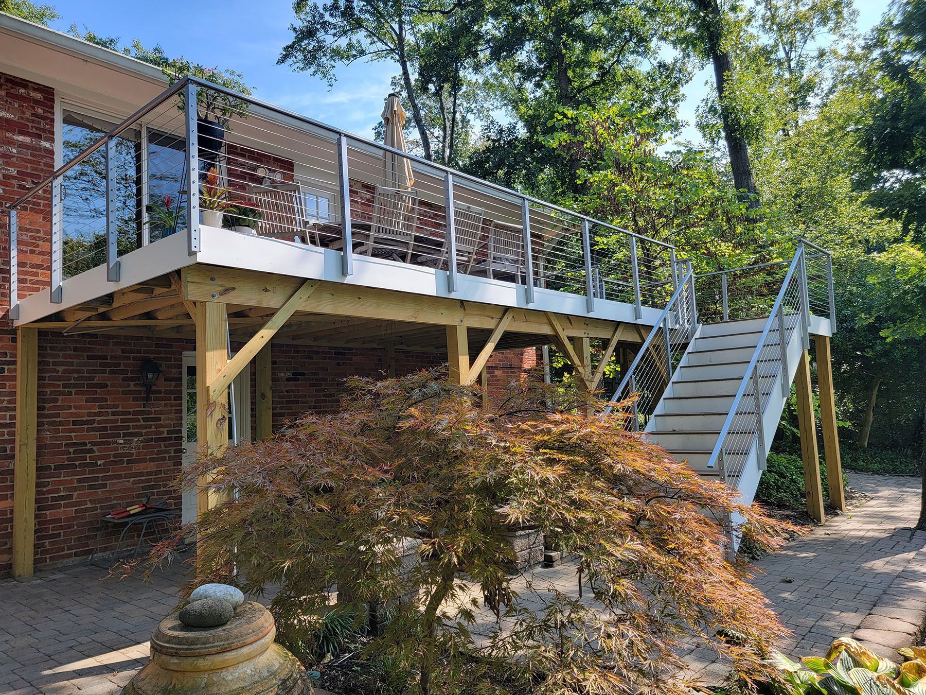 There is a large deck with stairs leading up to it.