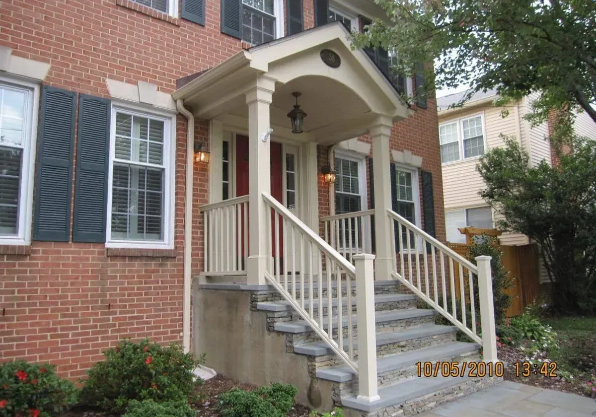 A brick house with a porch and stairs taken on october 13 2010
