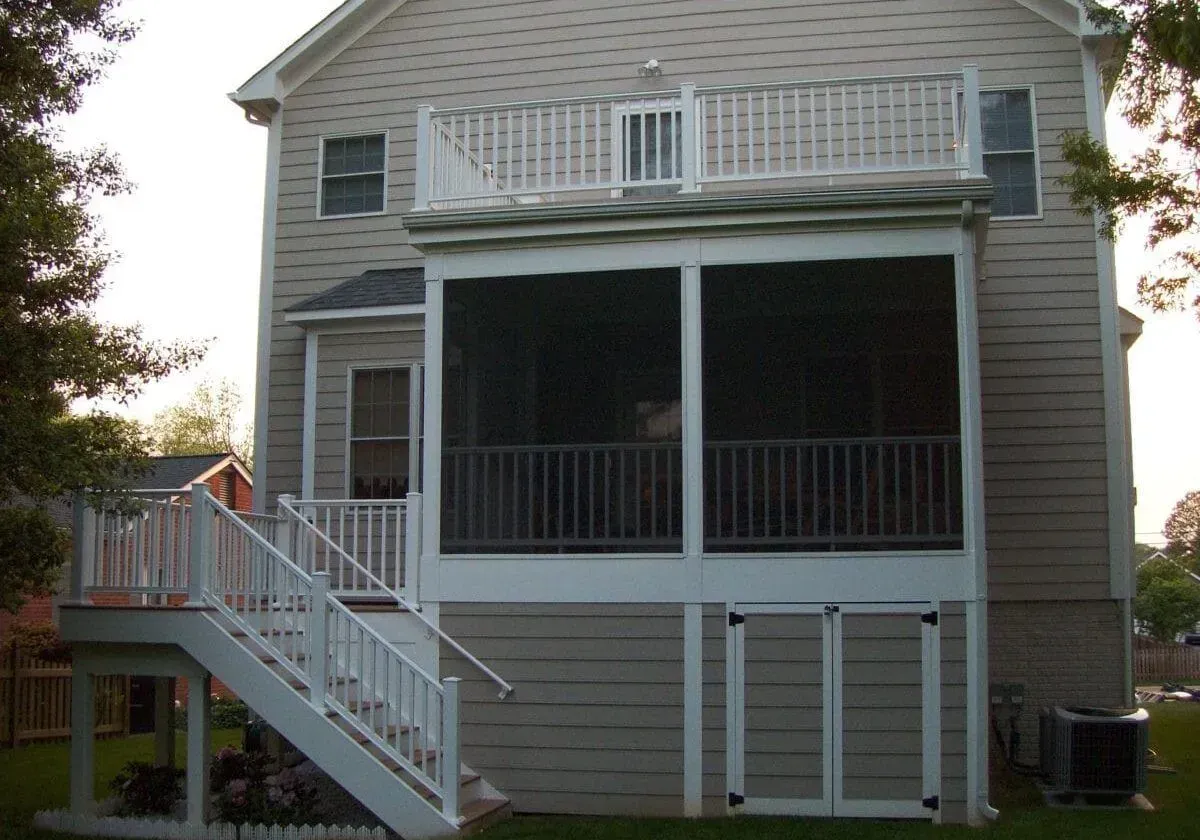A house with a screened in porch and stairs
