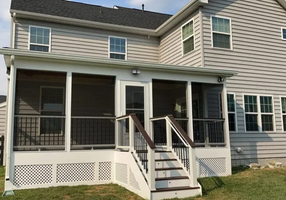 A house with a screened in porch and stairs