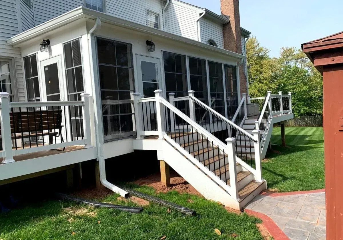 A screened in porch with stairs leading up to it