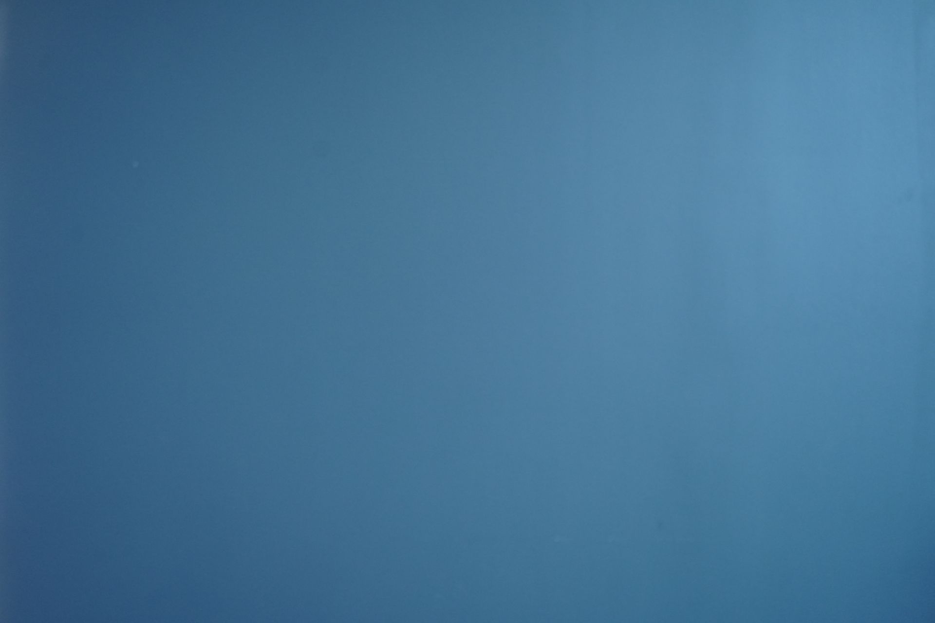 A close up of a blue background with a plain texture.