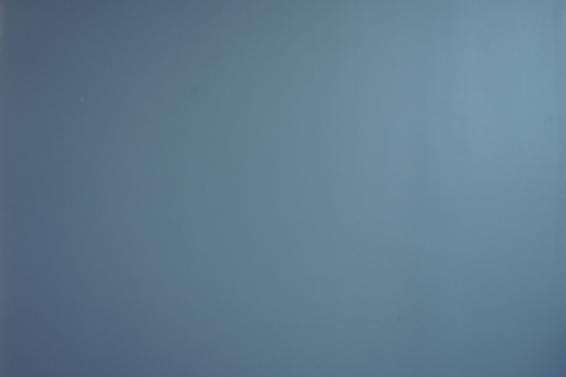 A close up of a blue background with a gray gradient.