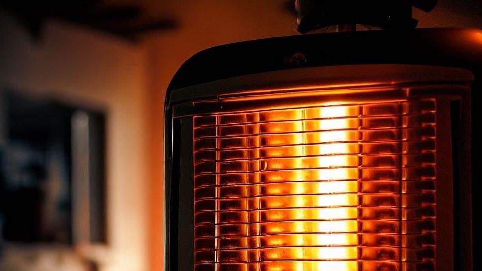 A close up of a heater with a flame coming out of it.