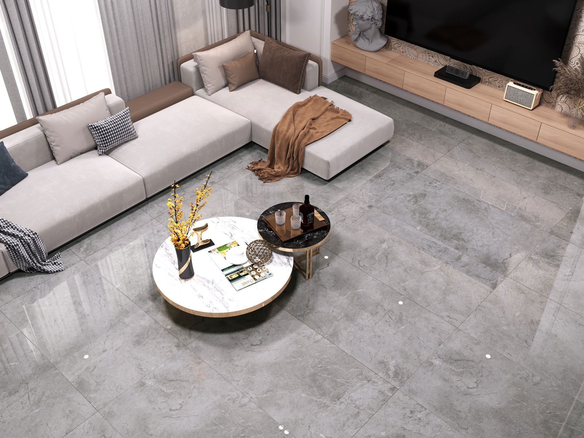 Living room with gray tile flooring, sectional sofa, and round coffee table.