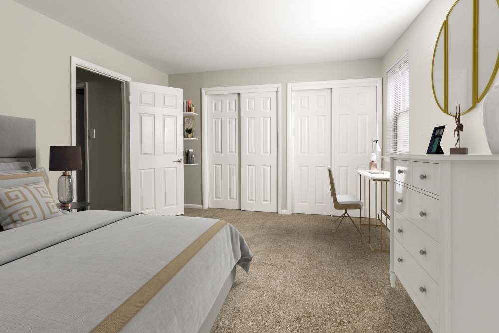 A bedroom featuring a bed with decorative pillows, a bedside lamp, a dresser, and a desk with a chair against a light,ed