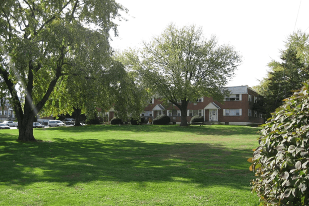 Well-maintained green space with residential buildings in the background.
