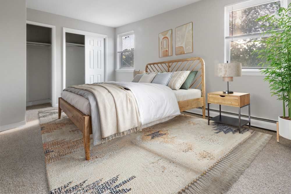 Cozy bedroom featuring a wooden bed frame and soft decor.