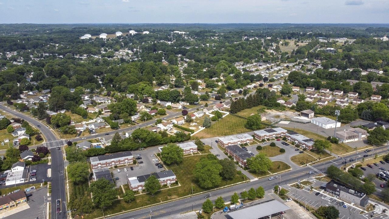 Aerial view of a residential community with houses and green spaces.