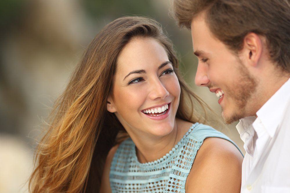Young Couple Smiling At Each Other — All Body Holistic Health in Hermit Park, QLD