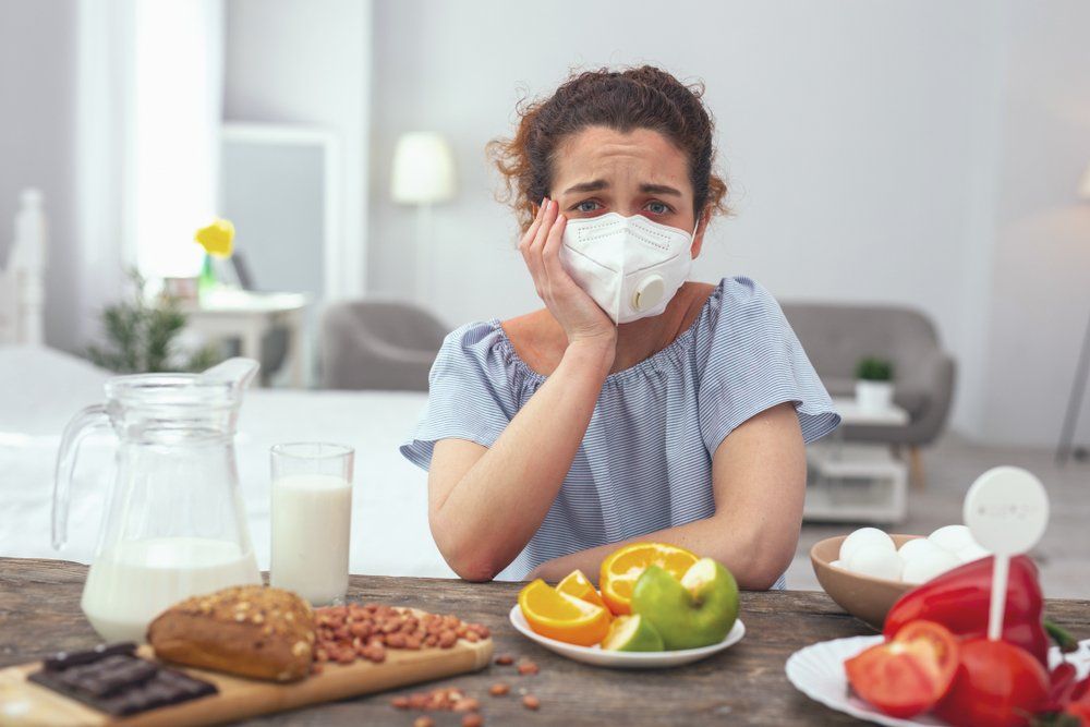 Young Woman Wearing Face Mask In Front Of Food — All Body Holistic Health in Hermit Park, QLD