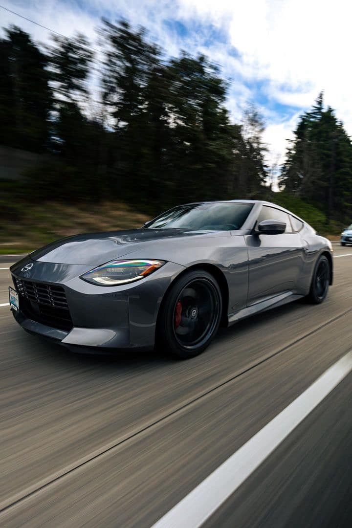 A close up of water drops on the hood of a car