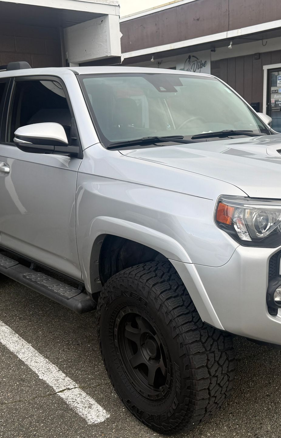Orange Dodge Charger Daytona with gray spoiler and side stripe.