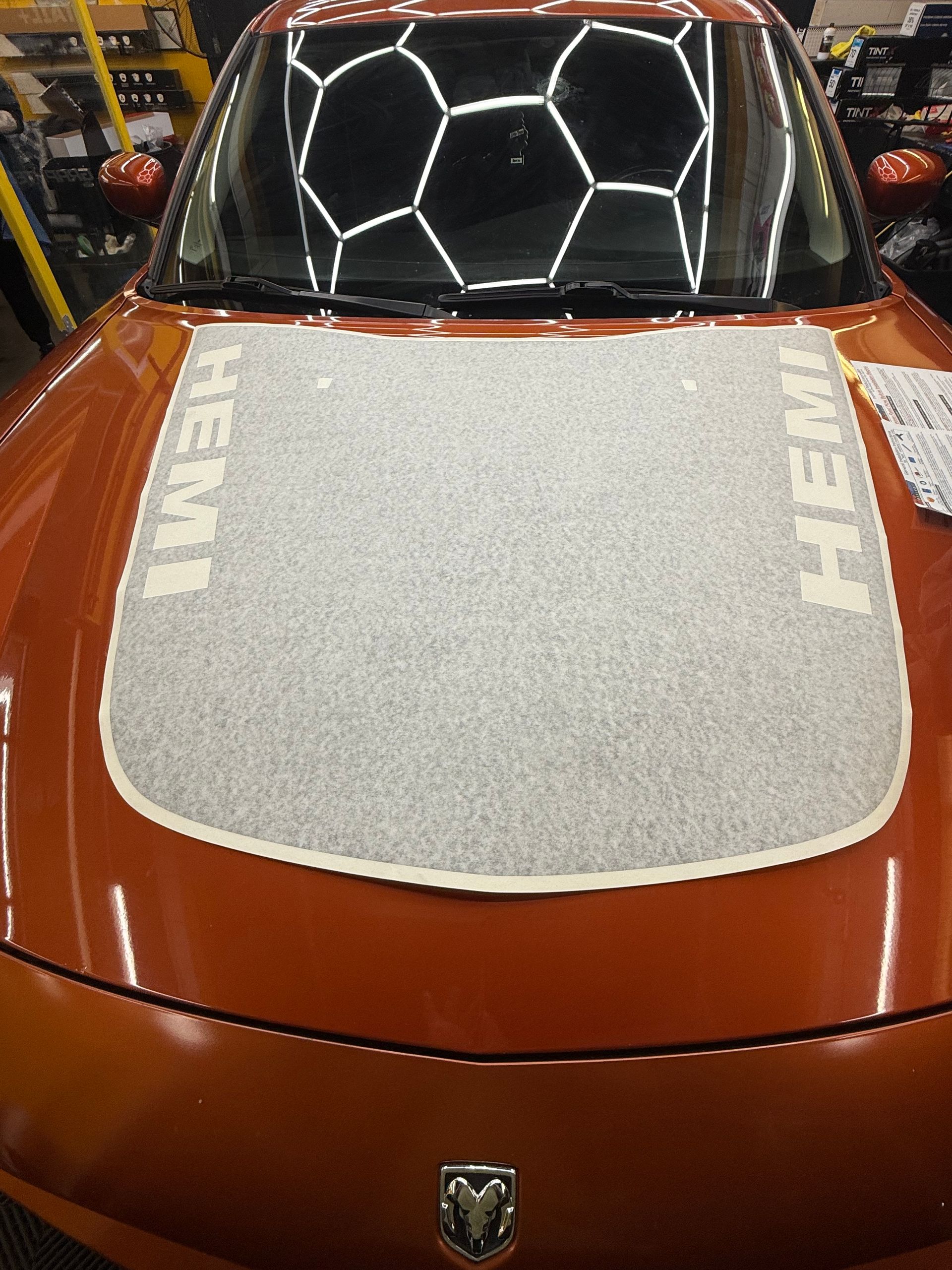 Orange car hood with a gray textured overlay and 