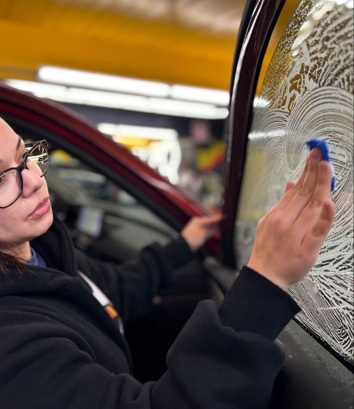 A black ford f150 is parked in a garage.
