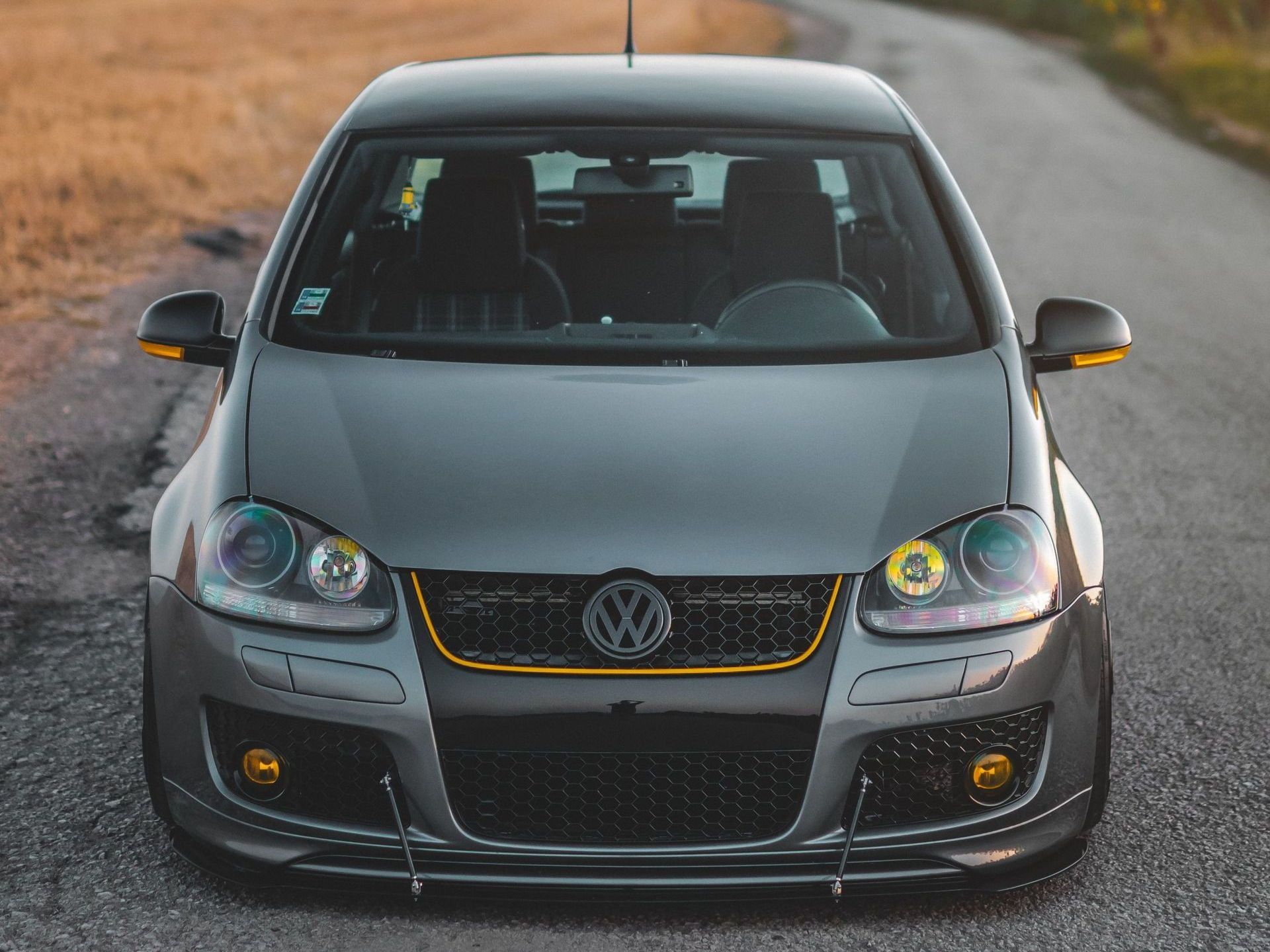 A volkswagen is parked on the side of a road.