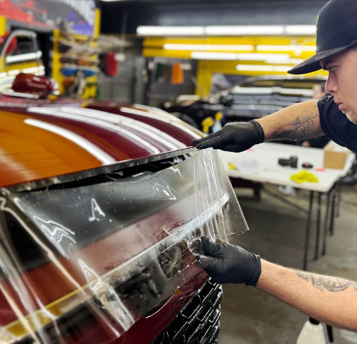 A man is working on a motorcycle in a garage.