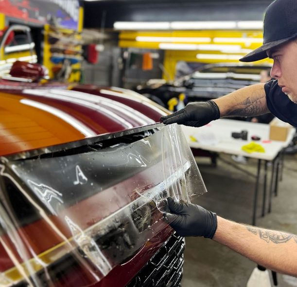 A man is working on a motorcycle in a garage.