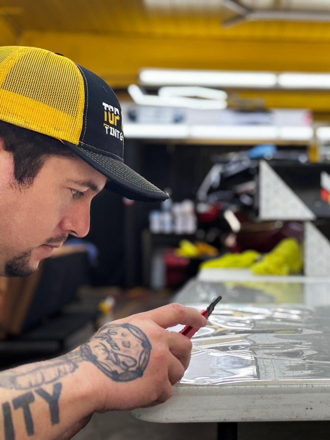 A man has a tattoo on his arm that says utility