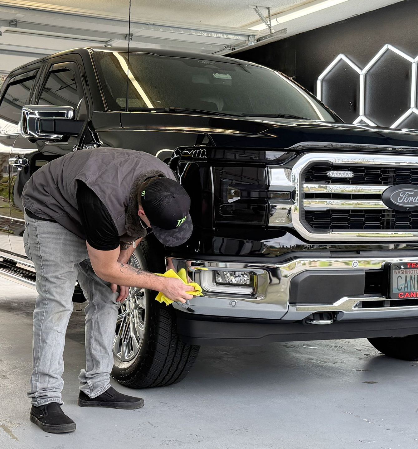 A woman is standing in front of a large printer.