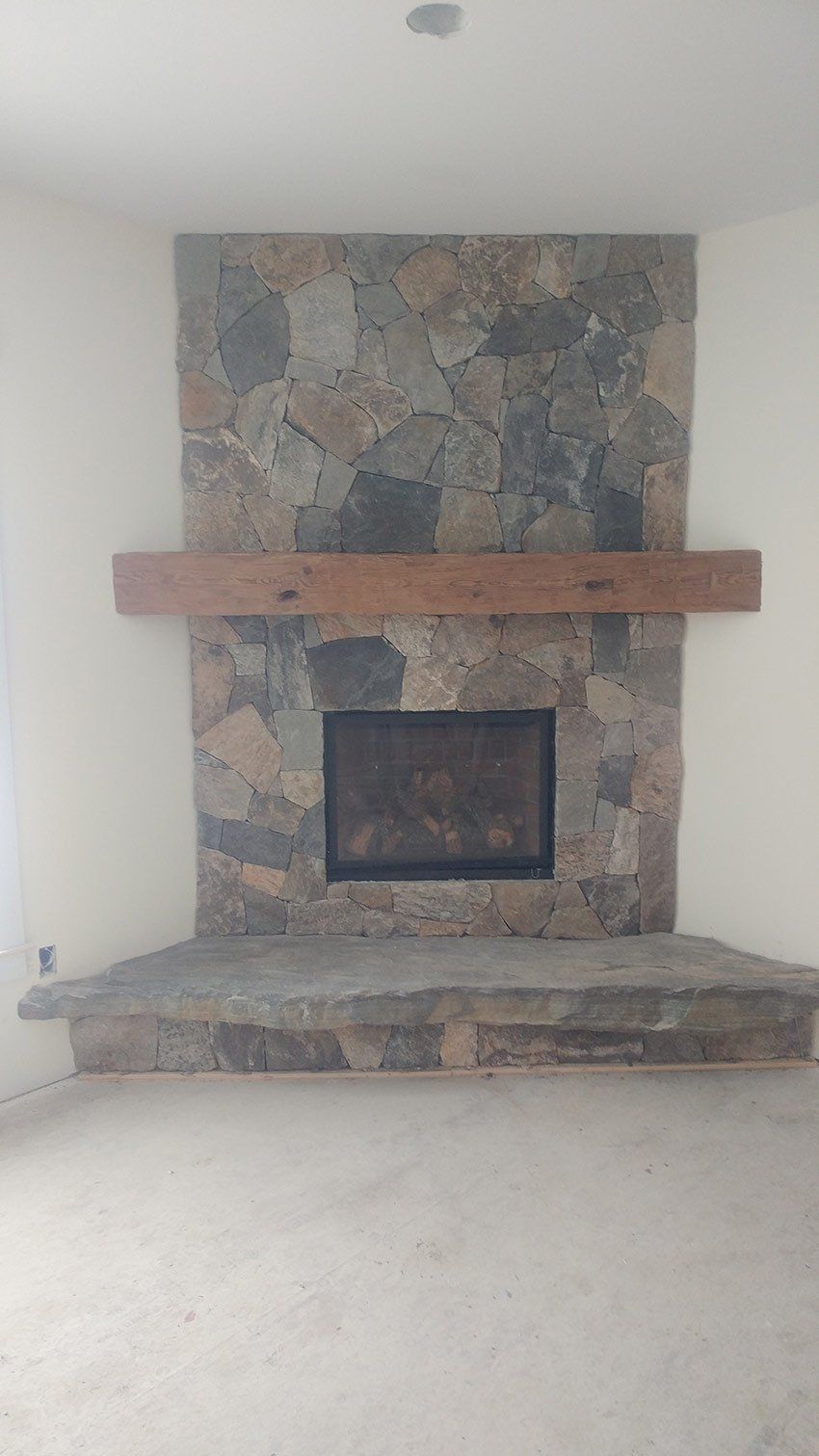 There is a fireplace in the middle of the room.