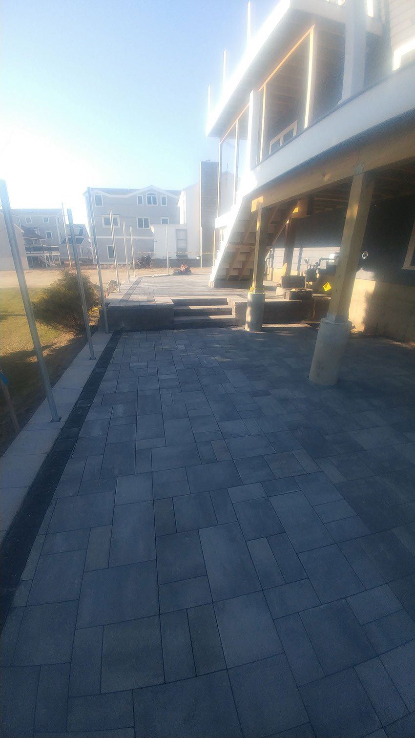 A large building with stairs leading up to it and a patio in front of it.