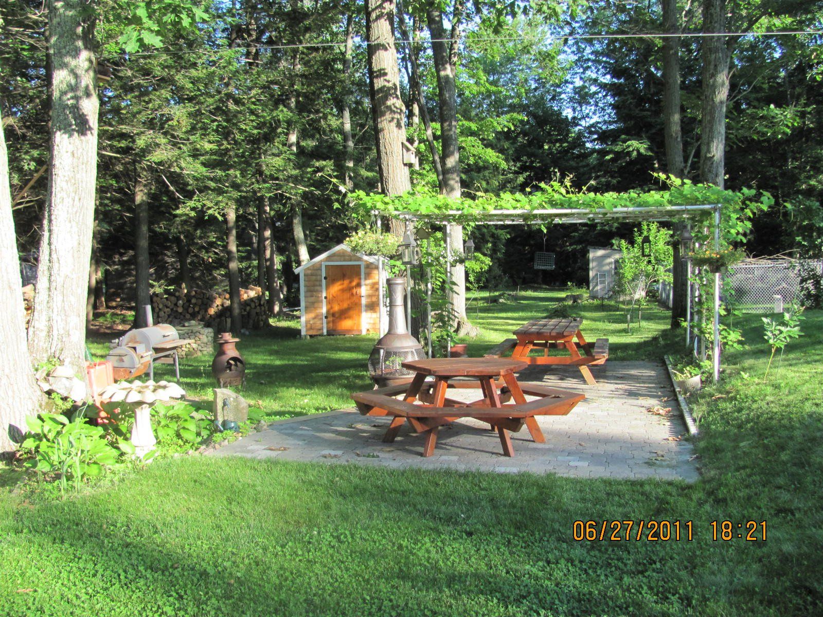 A picnic area with a shed in the background